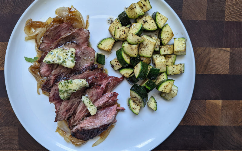 GRILLED BEEF FLANK STEAK WITH HERB BUTTER AND CARAMELIZED ONIONS BY CHEF JONATHAN MAYER